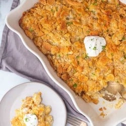 party potatoes in a dish with a plate of potatoes next to it