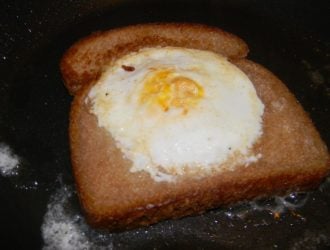 An egg in a hole is a egg that has been pan fried in a slice of bread. When you break it open the bread starts to soak up all the yolk.