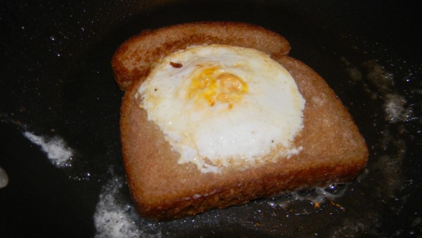 An egg in a hole is a egg that has been pan fried in a slice of bread. When you break it open the bread starts to soak up all the yolk.