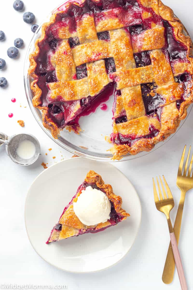 Slice of blueberry pie with ice cream on top