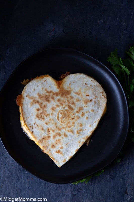 How to make a heart shaped quesadilla - heart shaped quesadilla on a black plate