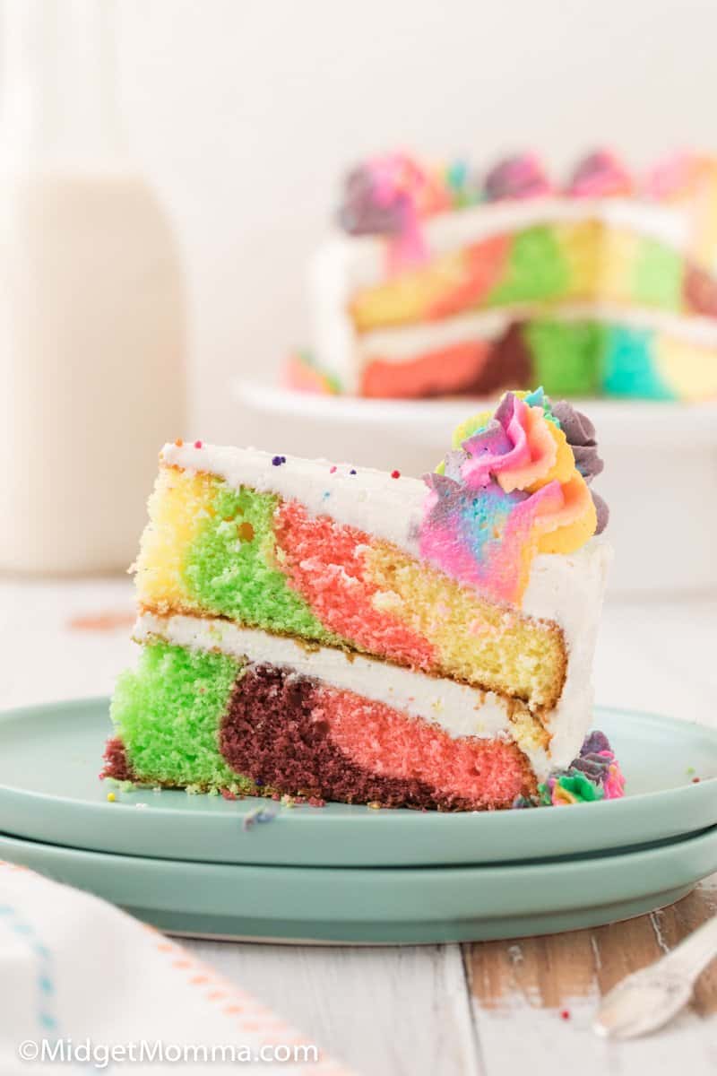 slice of rainbow cake on a plate