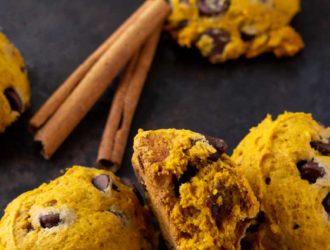 Baking sheet with pumpkin chocolate chip cookies and cinnamon sticks