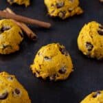 Soft pumpkin cookies with chocolate chips on a baking sheet