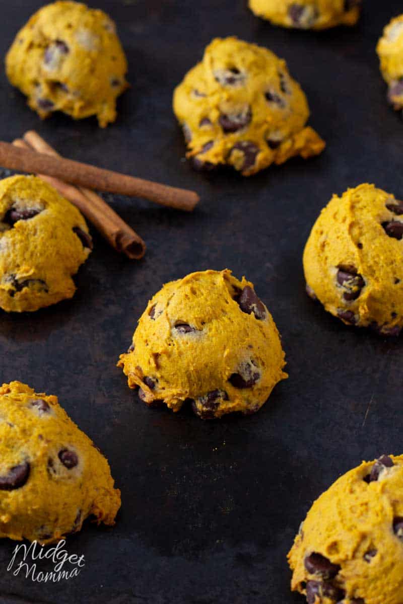 Soft pumpkin cookies with chocolate chips on a baking sheet