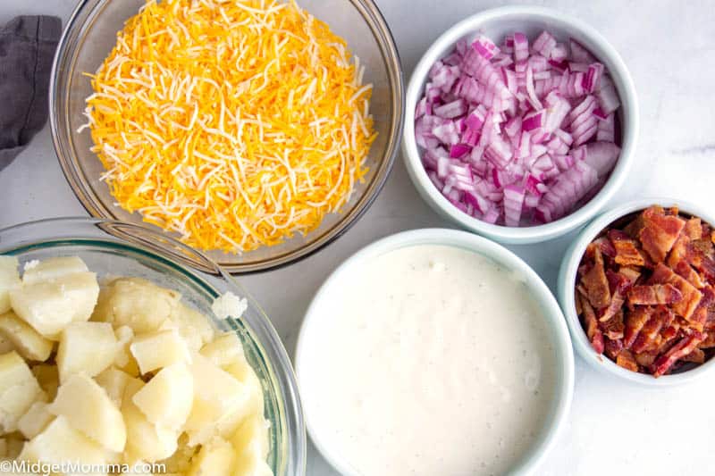 Loaded Bacon Ranch Potato Salad ingredients- bowls with potatoes, ranch dressing, red onion, bacon and cheese