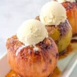 Baked Apples- on a white serving platter topped with vanilla ice cream