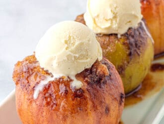 Baked Apples- on a white serving platter topped with vanilla ice cream