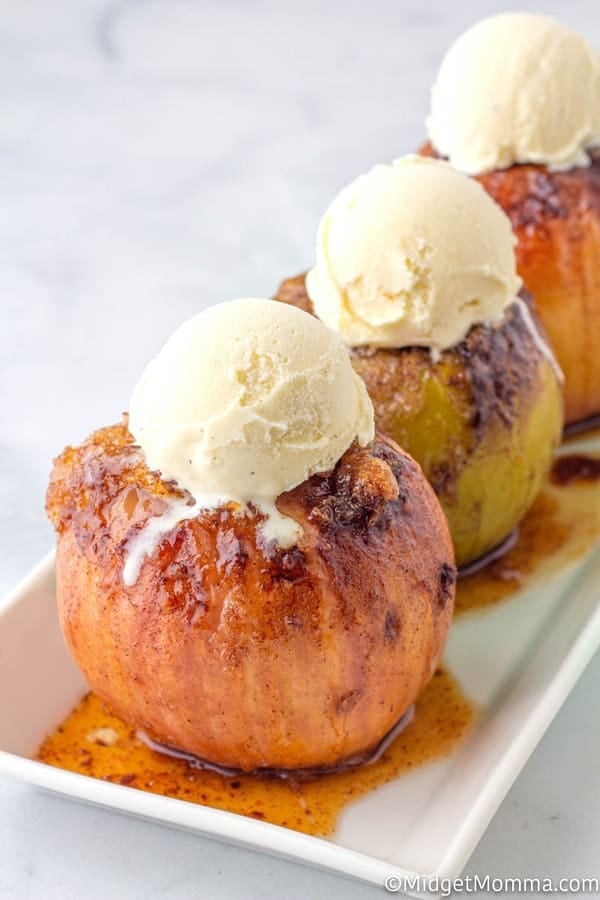 Baked Apples- on a white serving platter topped with vanilla ice cream