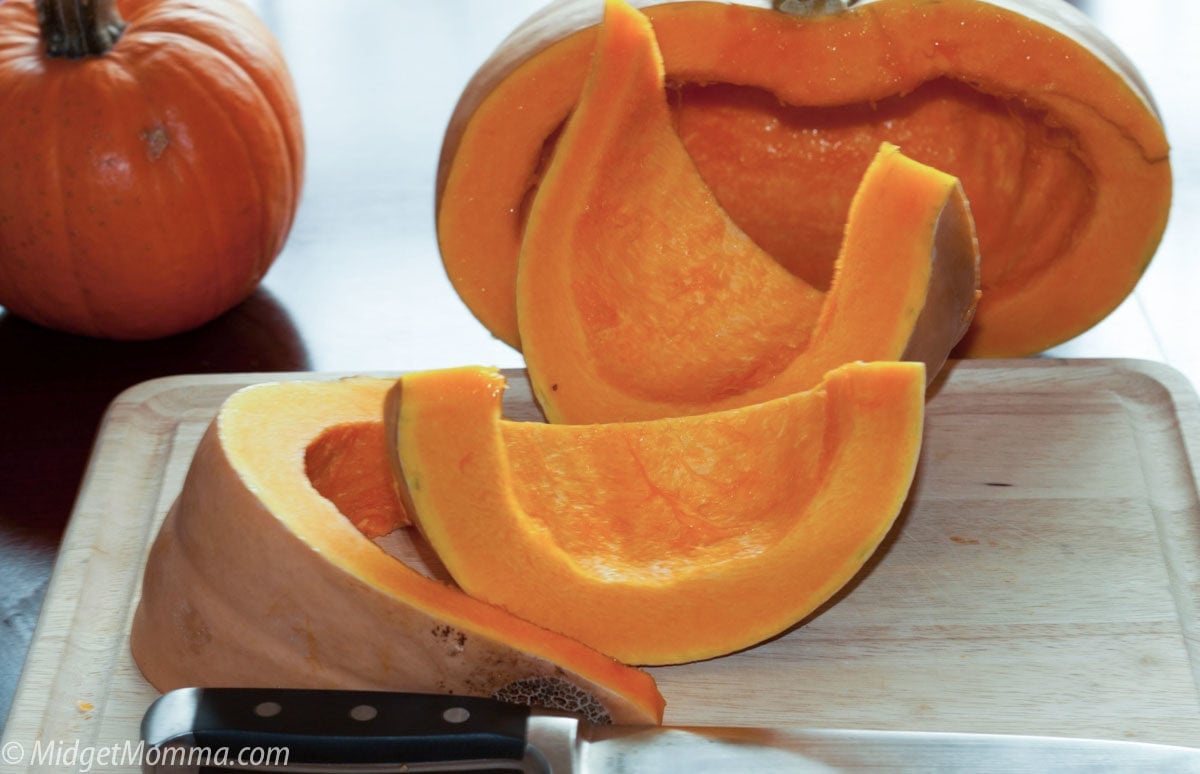 cutting uncooked pumpkin into wedges