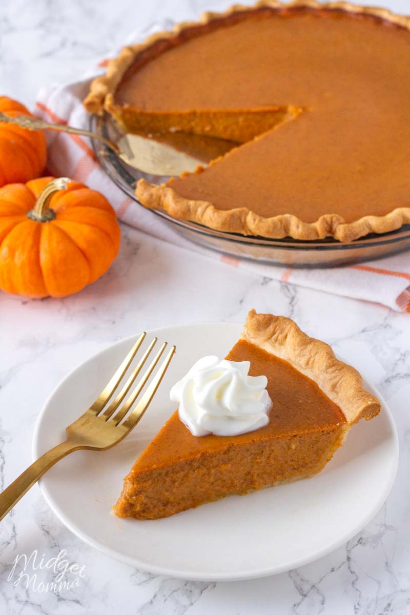 pumpkin pie made with fresh pumpkin on a plate topped with whipped cream