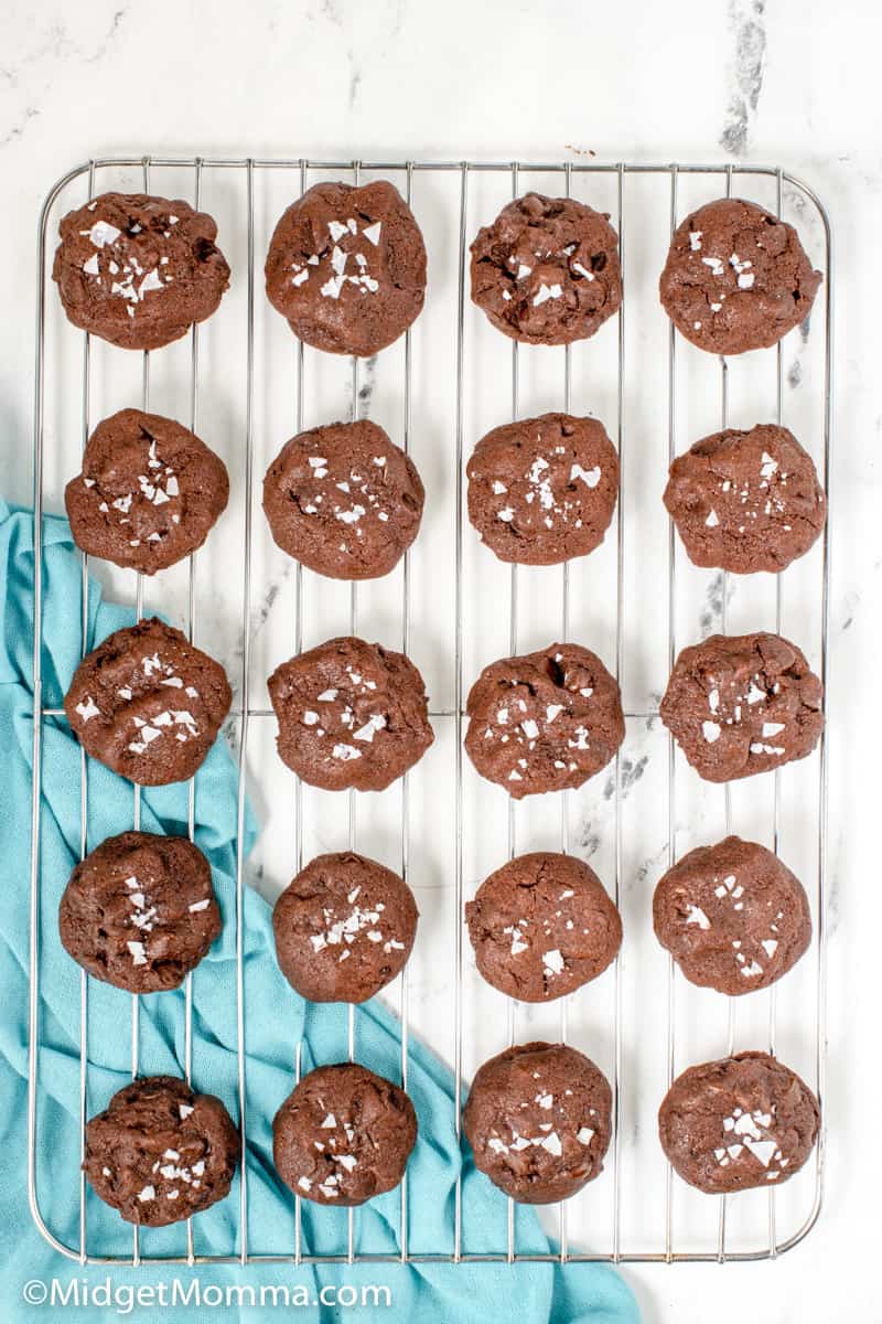 caramel stuffed chocolate cookies cooling on a baking sheet