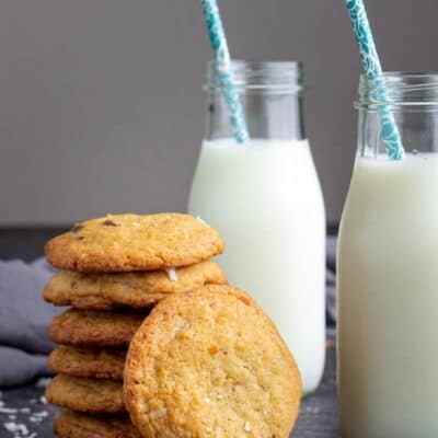 coconut chocolate chip cookies recipe - baked and cooled cookies in a stack with a glass of milk
