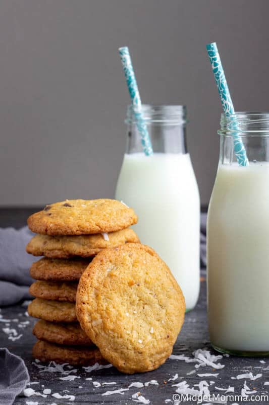 coconut chocolate chip cookies recipe - baked and cooled cookies in a stack with a glass of milk