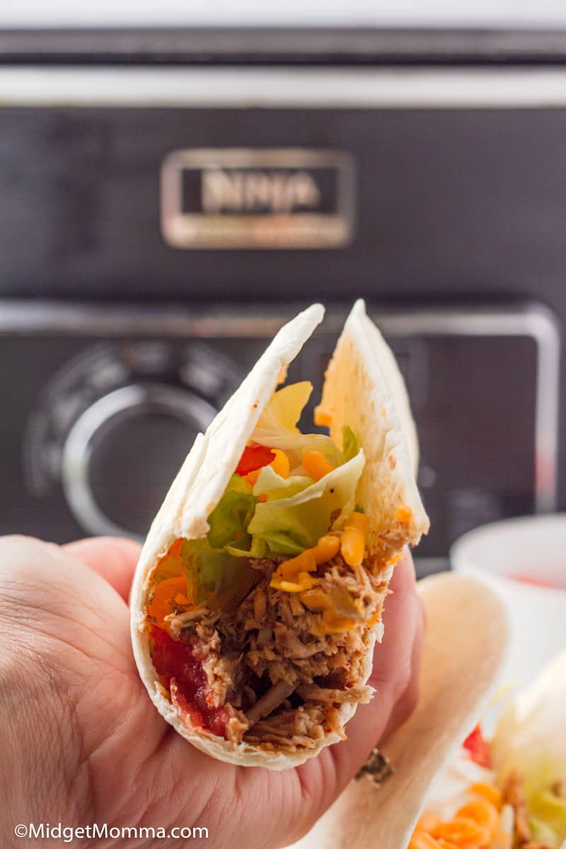 chicken taco being held with a hand