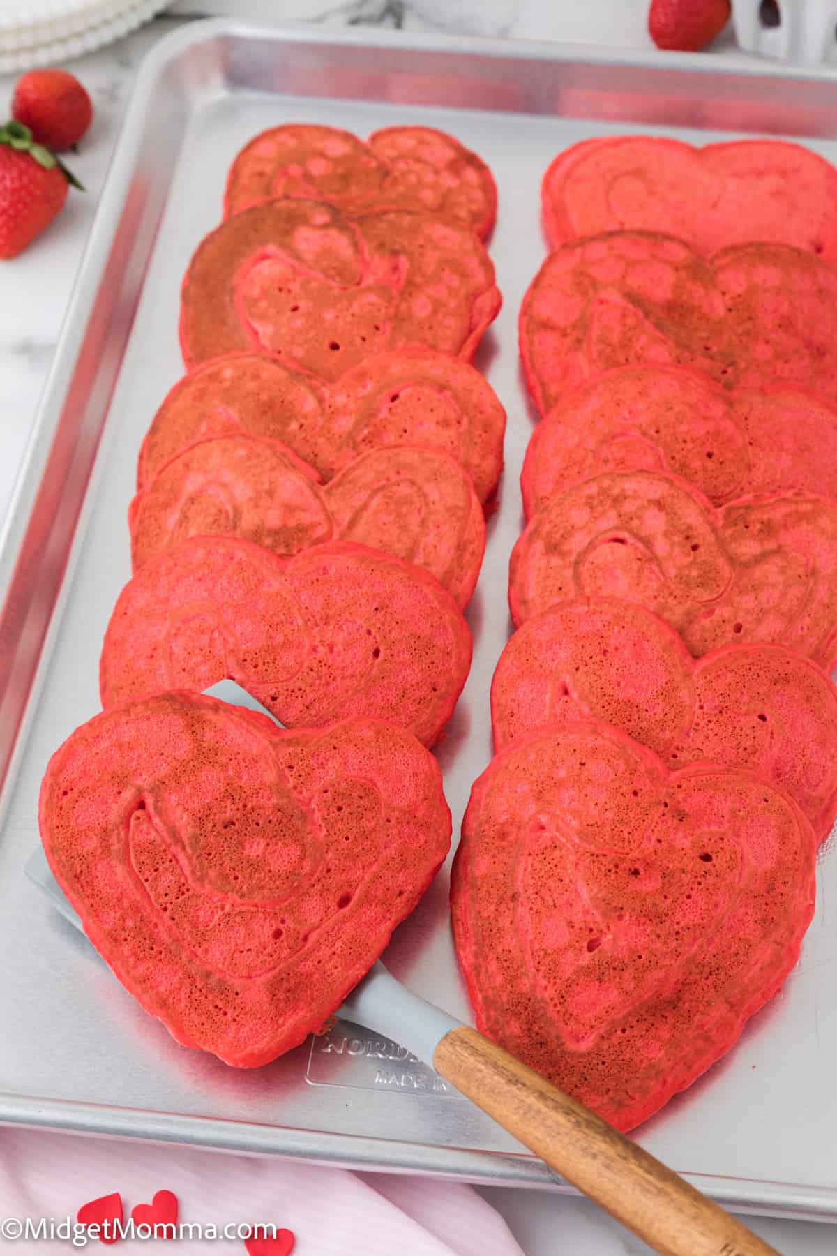 heart shaped pancakes on a baking sheet 
