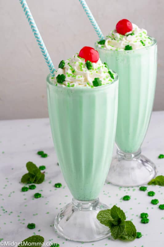 2 shamrock shakes topped with homemade whipped cream and a cherry