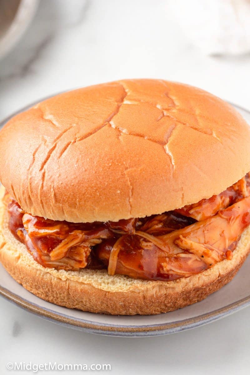 Slow Cooker Barbecue Pulled Chicken on a bun close up shot