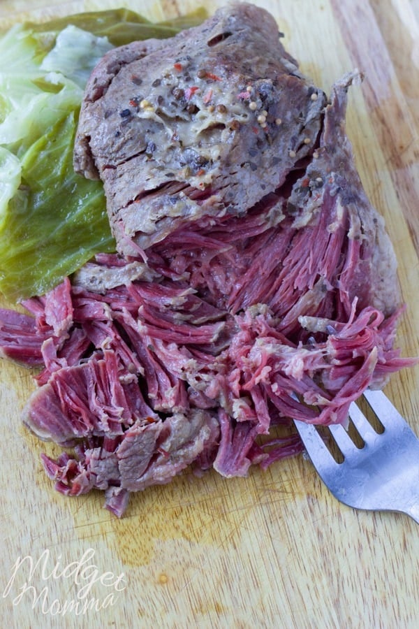 crockpot corned beef and cabbage cooling on a cutting board