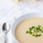 bowl of cauliflower and cheese soup made in the crockpot