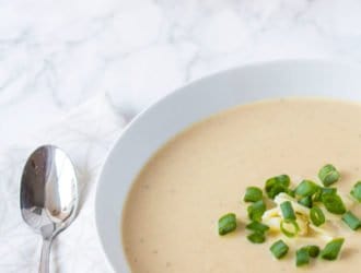 bowl of cauliflower and cheese soup made in the crockpot