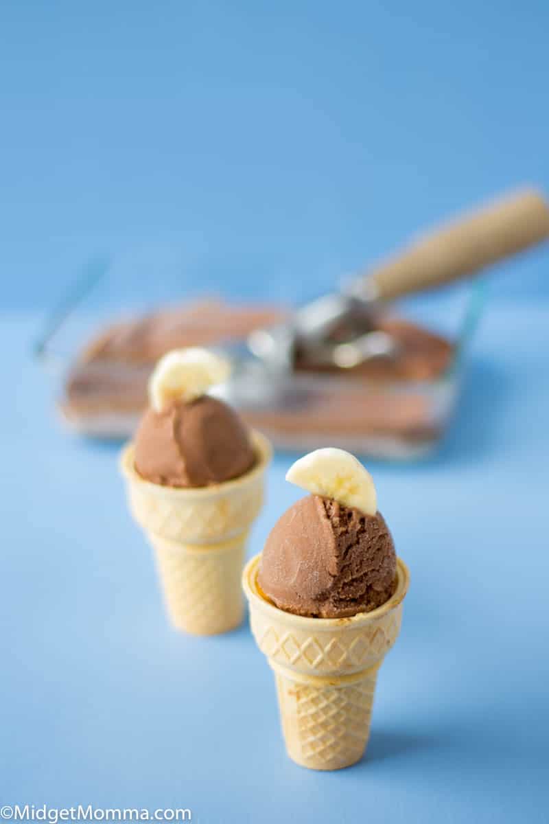 Dish with homemade banana ice cream and 2 cones filled with ice cream