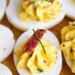 Close up shot of deviled egg with bacon
