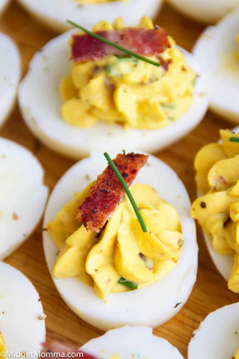 Close up shot of deviled egg with bacon