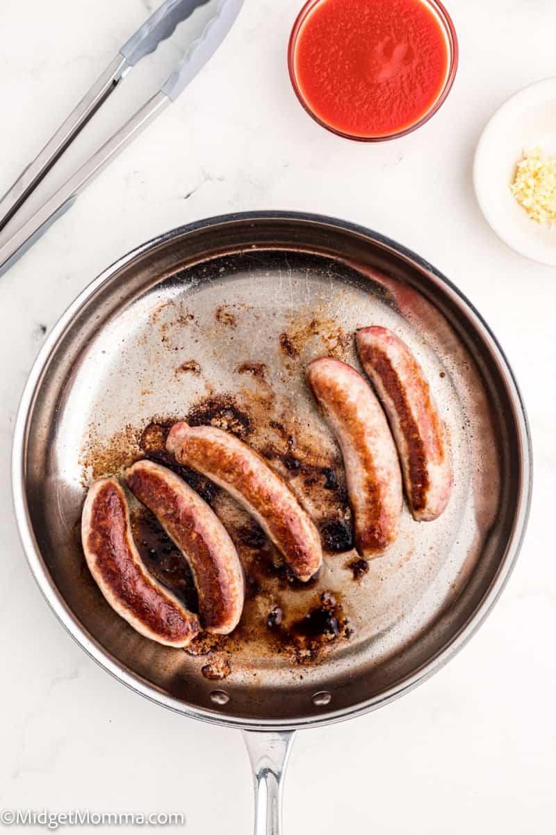Italian Sausage cooking in a pan
