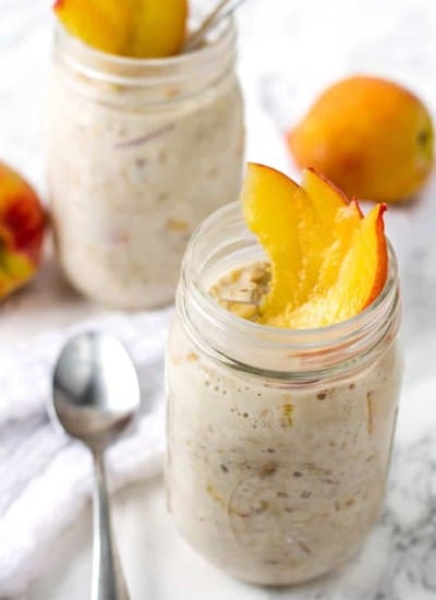 Easy overnight oats with peaches in a mason jar with a spoon