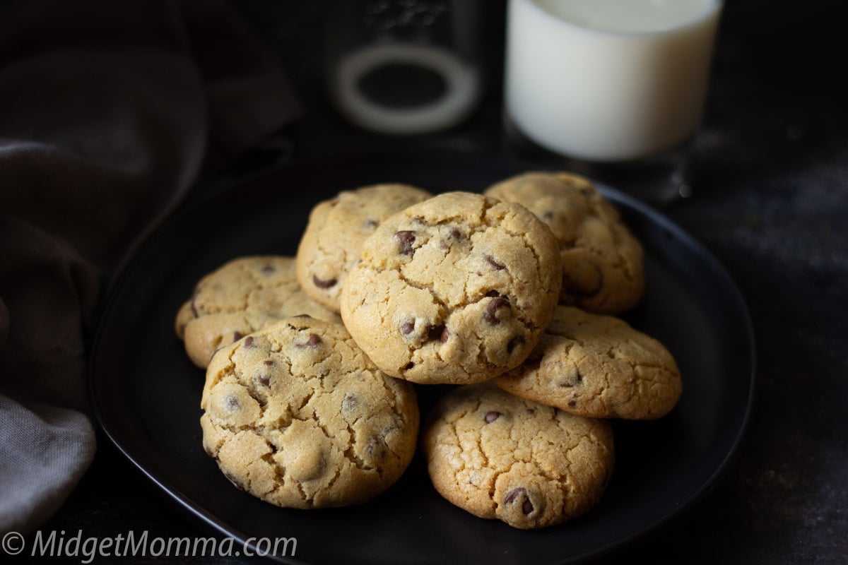homemade chocolate chip cookies on a plate with a glass of milk