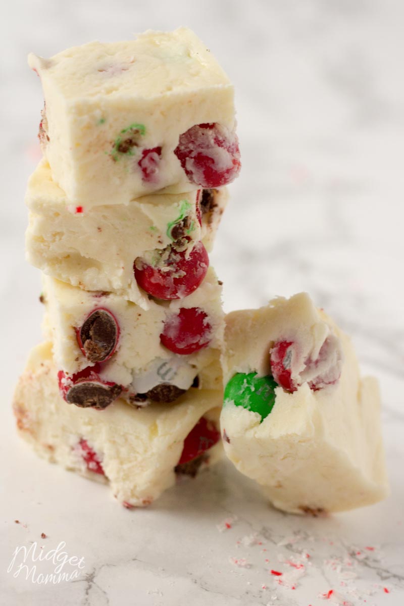 3 pieces of 3 Ingredient White Chocolate Peppermint Fudge stacked on top of each other.