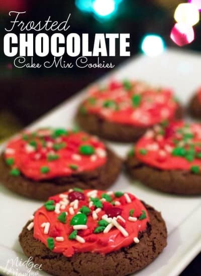 Fresh baked chocolate cake cookies with red frosting and christmas sprinkles