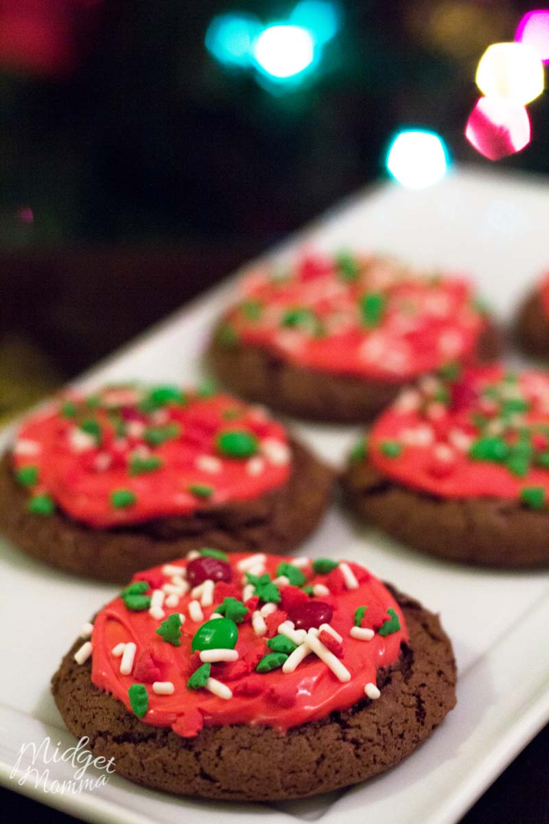 Fresh baked chocolate cake cookies with red frosting and christmas sprinkles