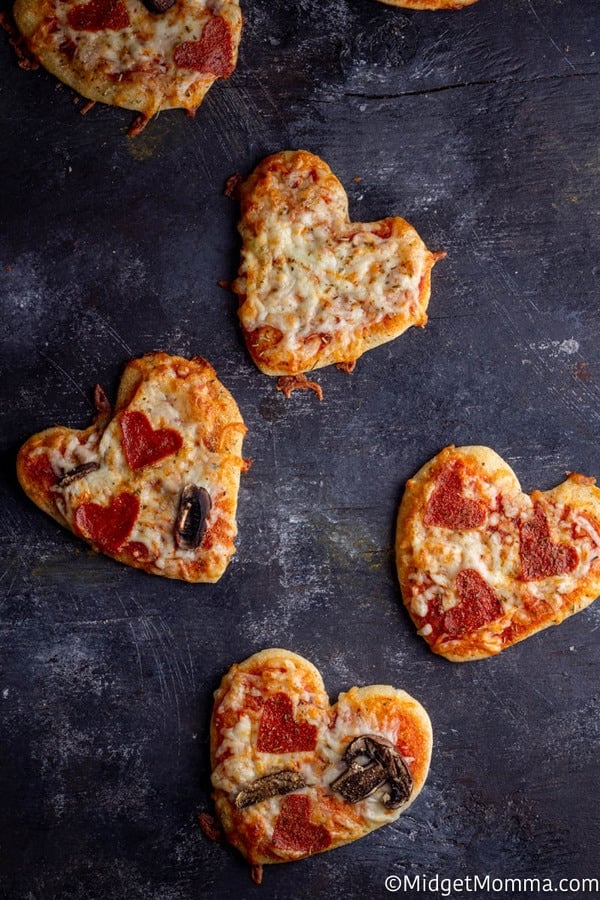 heart shaped pizza on a baking sheet