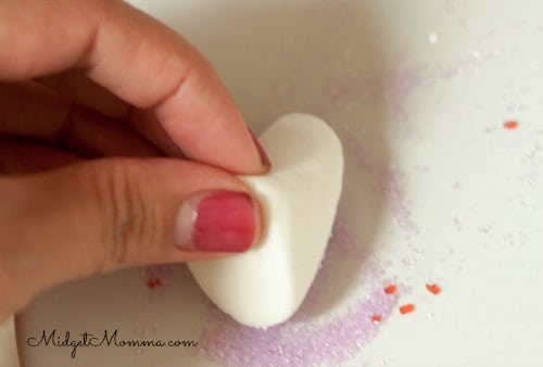 bunny cupcake marshmallow ears being dipped in sanding sugar