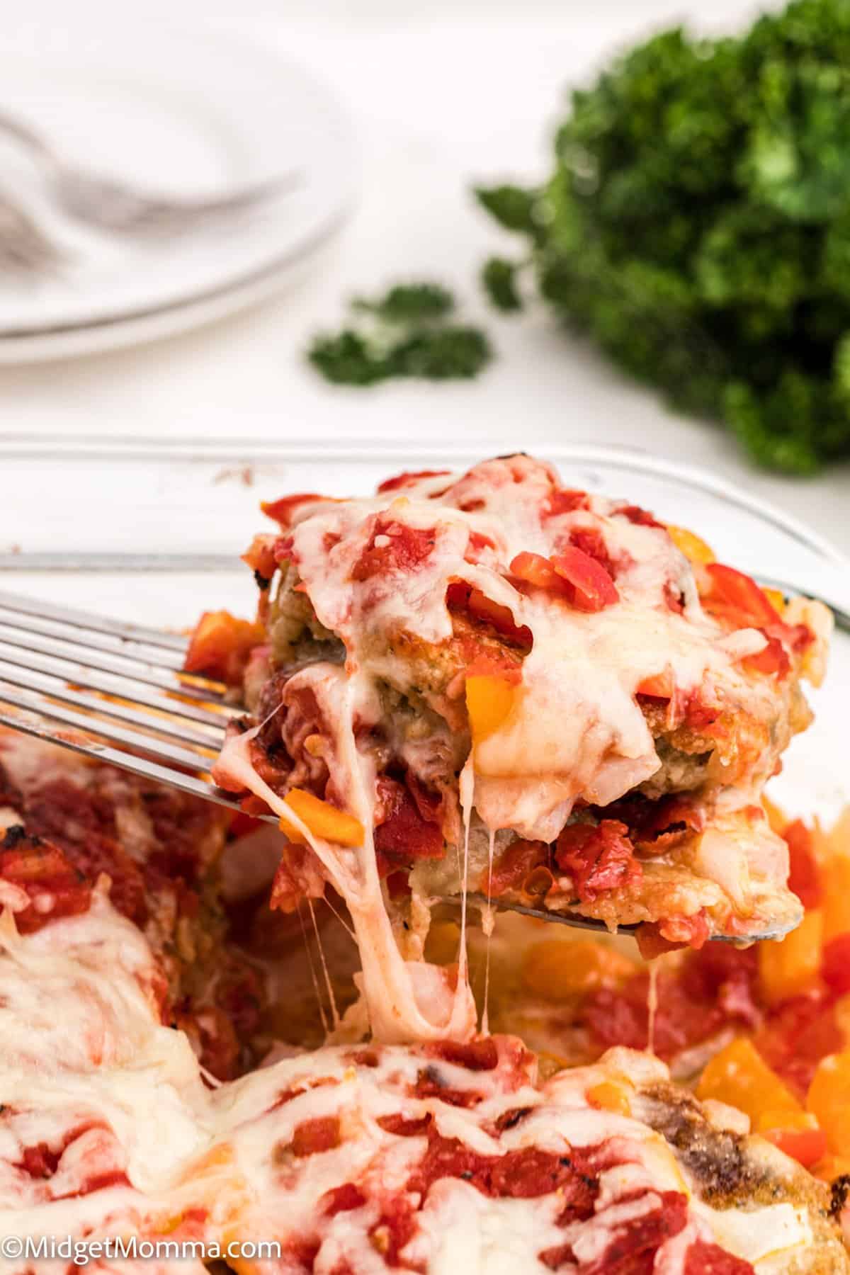 Baked Eggplant Parmesan being removed from the casserole dish with a serving spoon