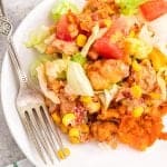 Cheesy Doritos Chicken Casserole serving on a white plate