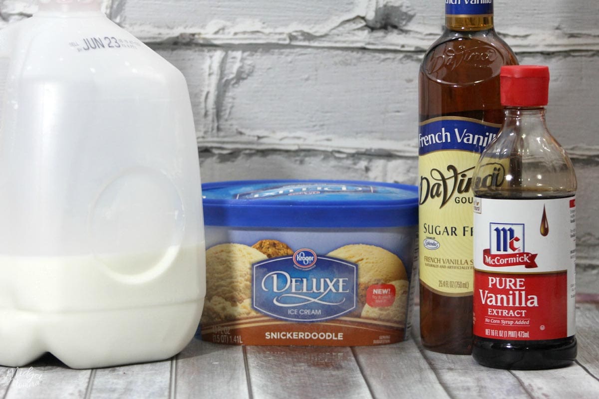 Cinnamon Roll Frappuccino ingredients including milk, ice cream, french vanilla flavoring and vanilla on the kitchen counter.