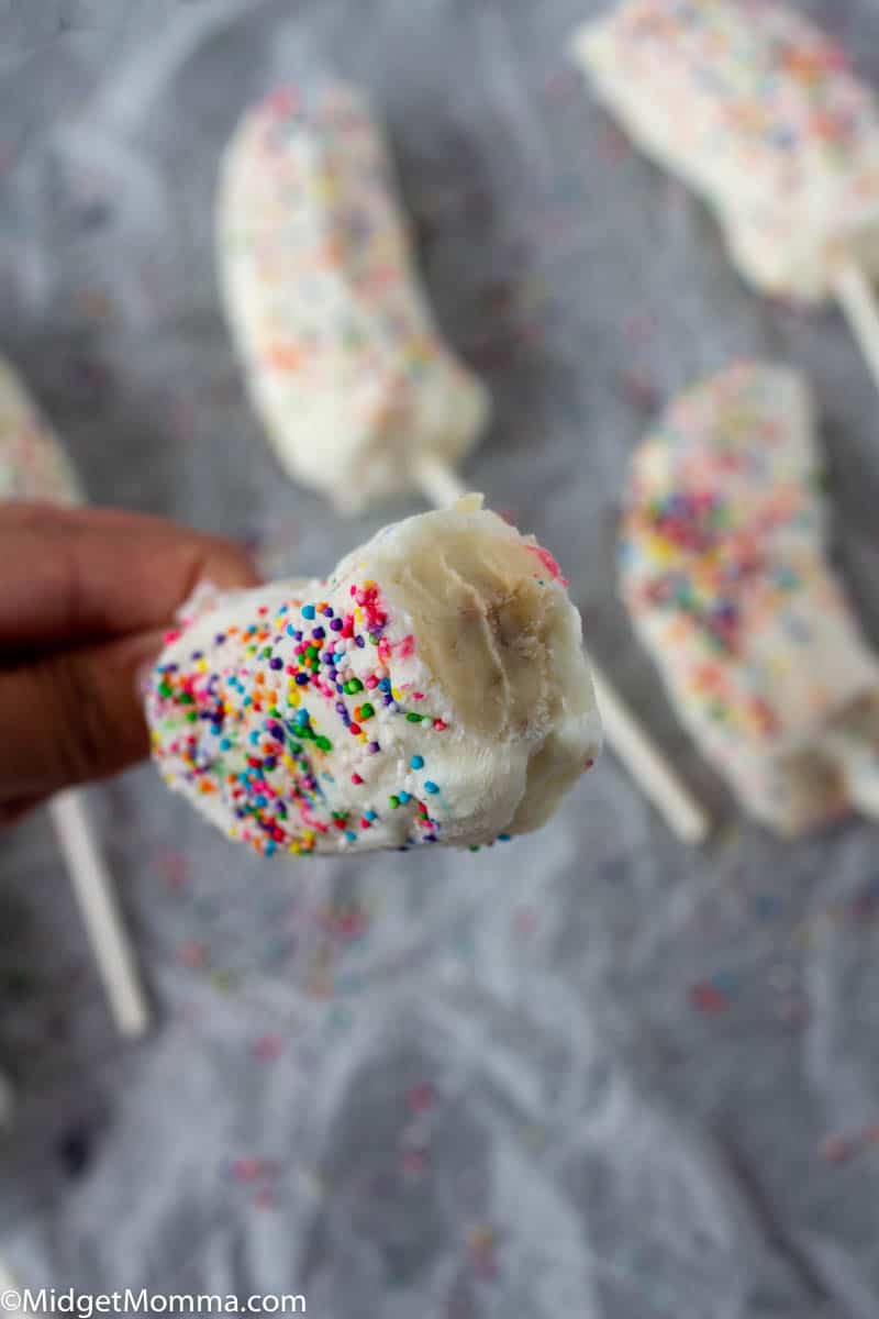 Banana Pop with sprinkles and a bite taken from it