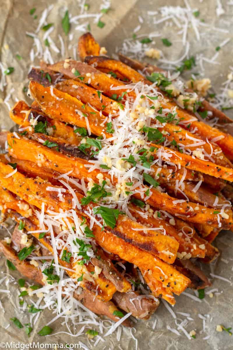 Pile of homemade sweet potatoes topped with garlic and parmesan cheese