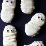 5 Nutterbutter Mummy Cookies on a black background