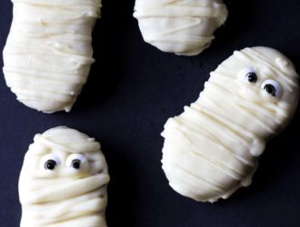 5 Nutterbutter Mummy Cookies on a black background