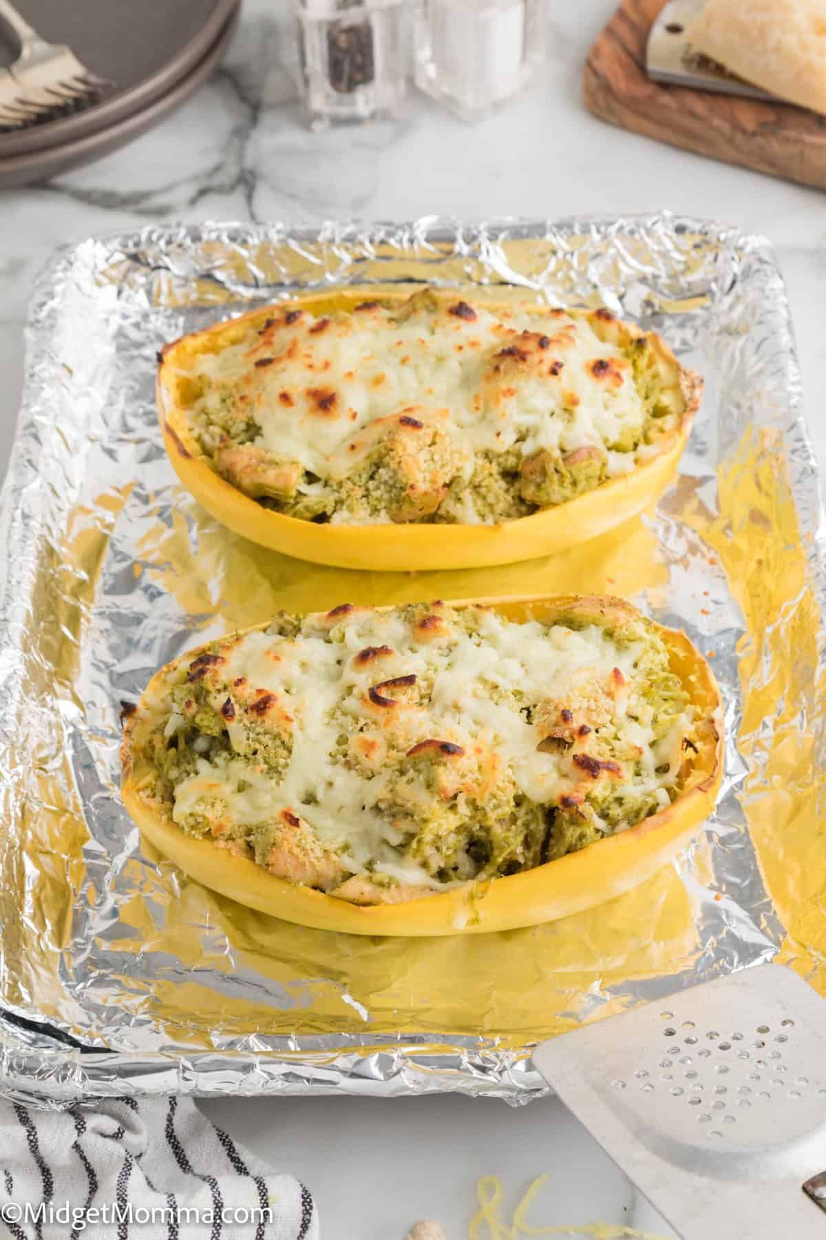 Pesto Chicken Spaghetti Squash Bowls on a tin foil lined baking sheet