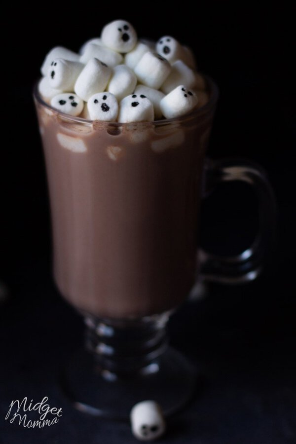 marshmallows with ghosts face in a glass of homemade halloween hot chocolate