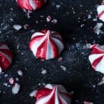 Close up photo of red and white peppermint meringue cookies