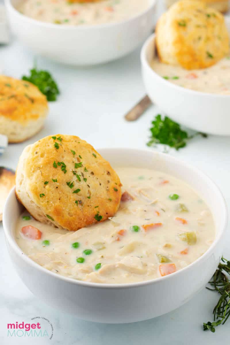 Chicken Pot Pie Soup in a bowl with a biscuit