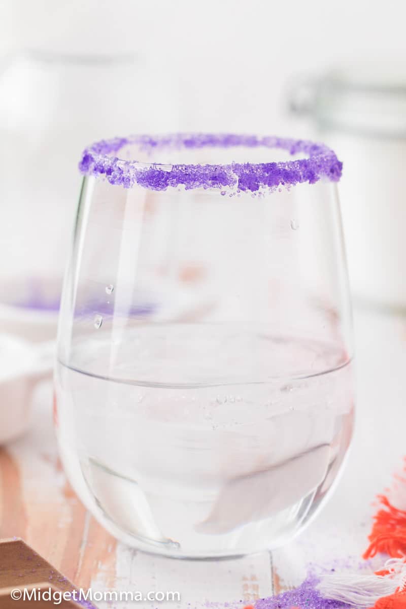 purple colored sugar on the rim of a glass