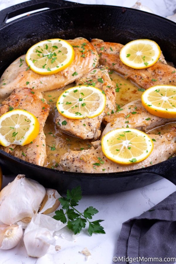 Lemon and garlic chicken in a black skillet