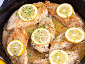 Lemon Garlic Chicken Recipe cooked in a black skillet on the counter